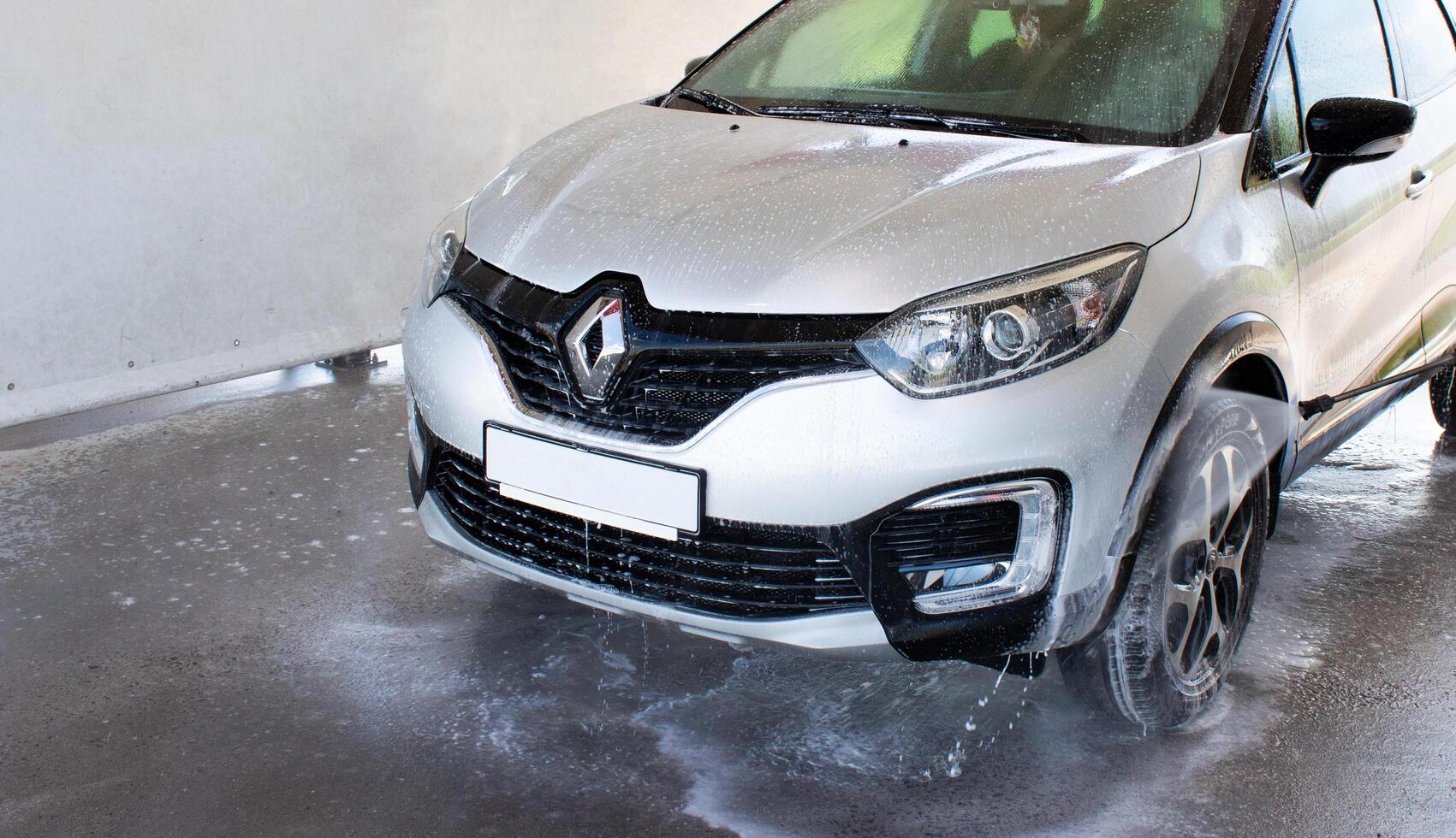 Grodno, Belarus - 06.01.2020 Washing a silver Renault Kaptur or Captur car on the first day of summer photo