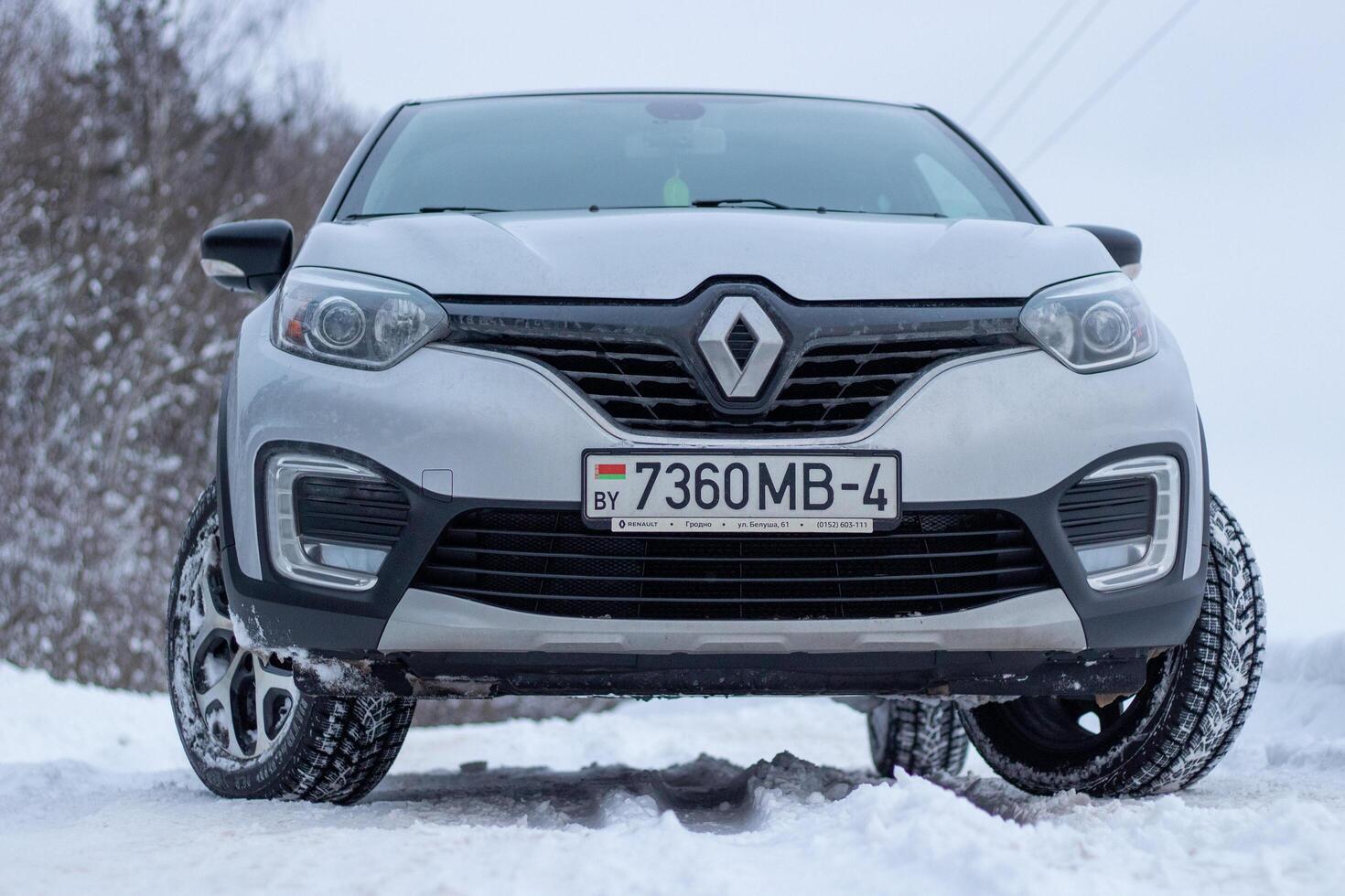 Grodno, Belarus-01.31.2021 Renault Kaptur or Renault Captur SUV on a winter road against the background of a field and forest. Winter driving conditions in Renault on a snowy road photo