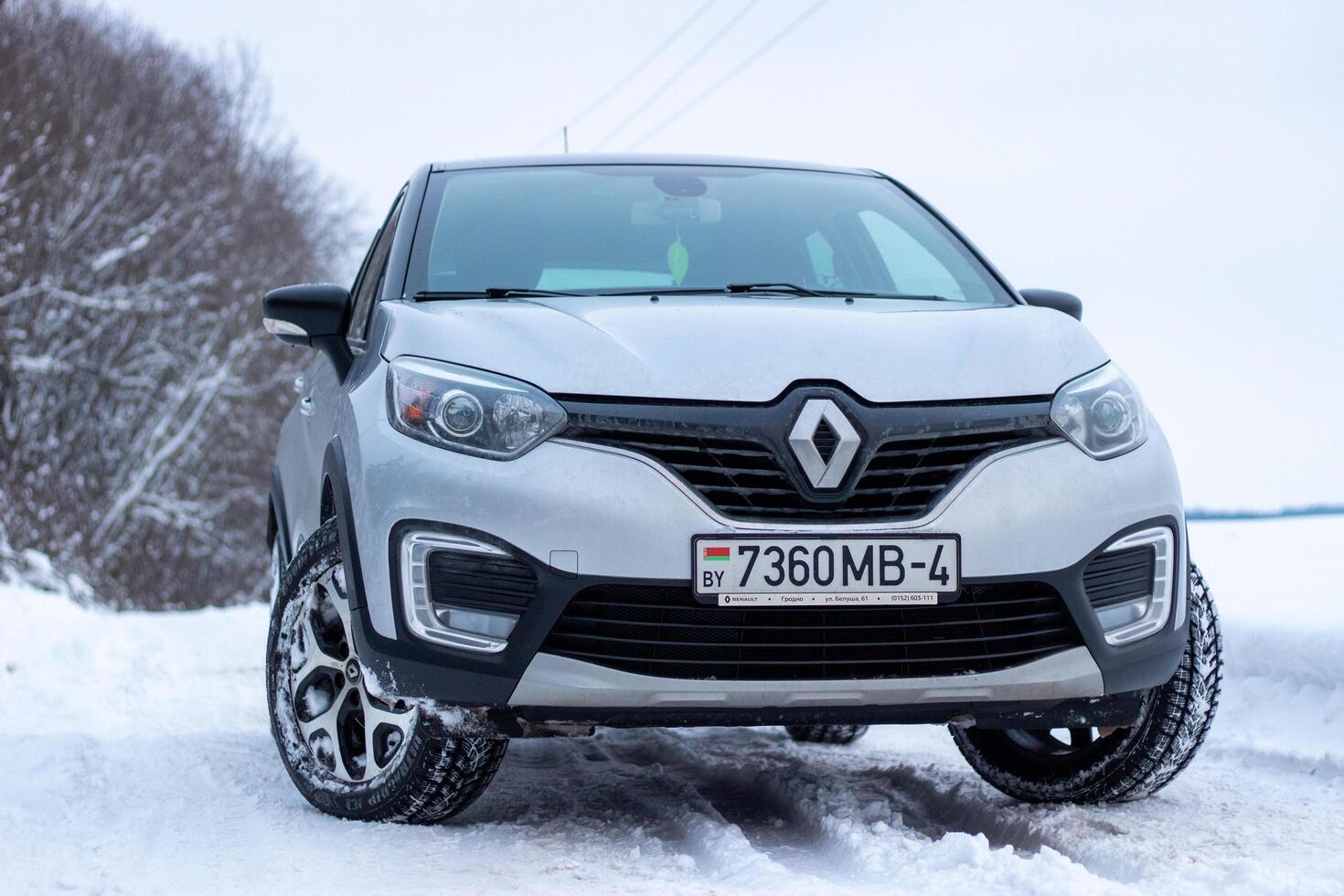Grodno, Belarus-01.31.2021 Renault Kaptur or Renault Captur SUV on a winter road against the background of a field and forest. Winter driving conditions in Renault on a snowy road photo