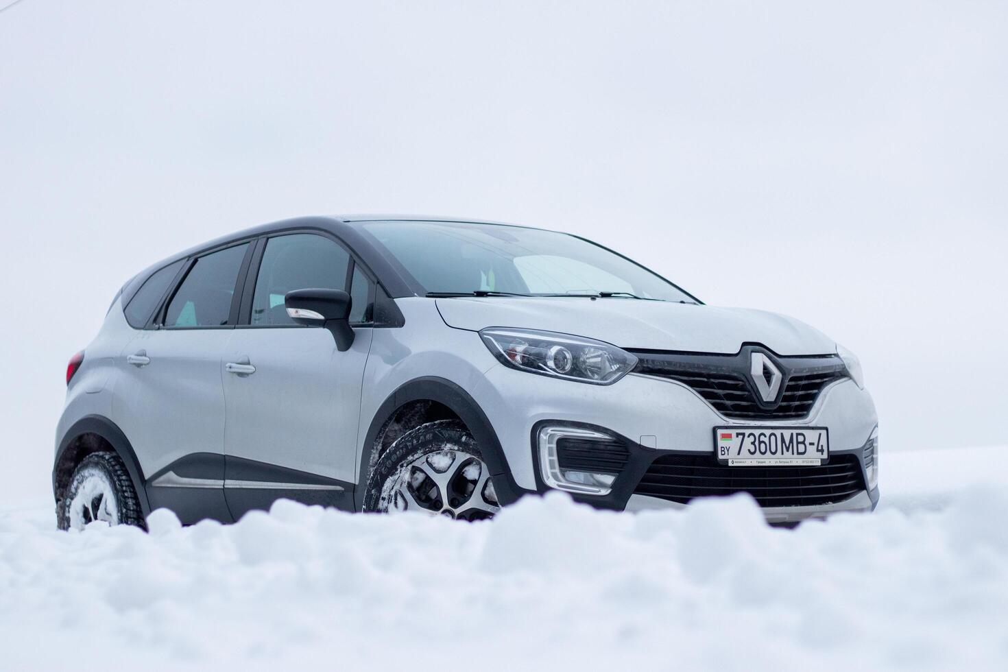 Grodno, Belarus-01.31.2021 Renault Kaptur or Renault Captur SUV on a winter road against the background of a field and forest. Winter driving conditions in Renault on a snowy road photo