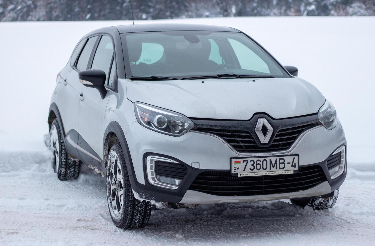 Grodno, Belarus-01.31.2021 Renault Kaptur or Renault Captur SUV on a winter road against the background of a field and forest. Winter driving conditions in Renault on a snowy road photo