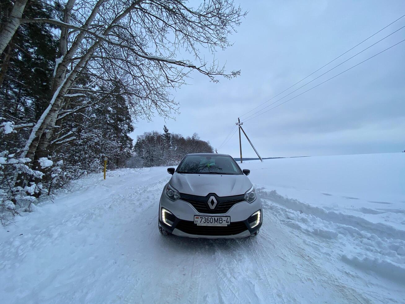 Grodno, Belarus-01.31.2021 Renault Kaptur or Renault Captur SUV on a winter road against the background of a field and forest. Winter driving conditions in Renault on a snowy road photo
