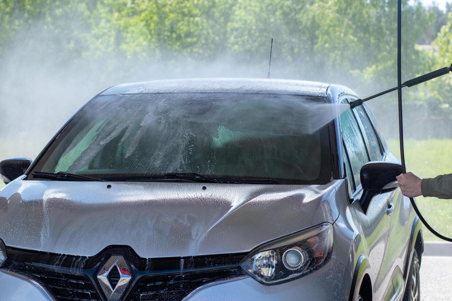 Grodno, Belarus - 06.01.2020 Washing a silver Renault Kaptur or Captur car on the first day of summer photo