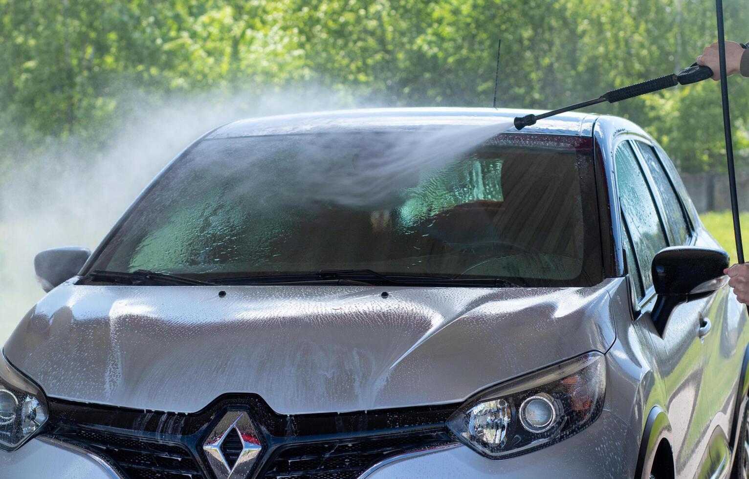Grodno, Belarus - 06.01.2020 Washing a silver Renault Kaptur or Captur car on the first day of summer photo