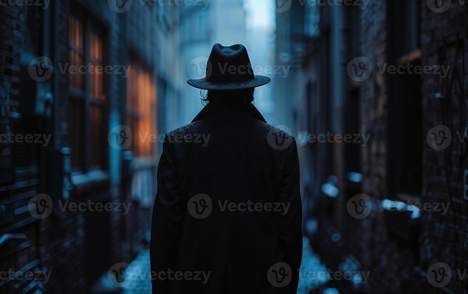 Detective walking down a shadowy, snow dusted alleyway at twilight photo