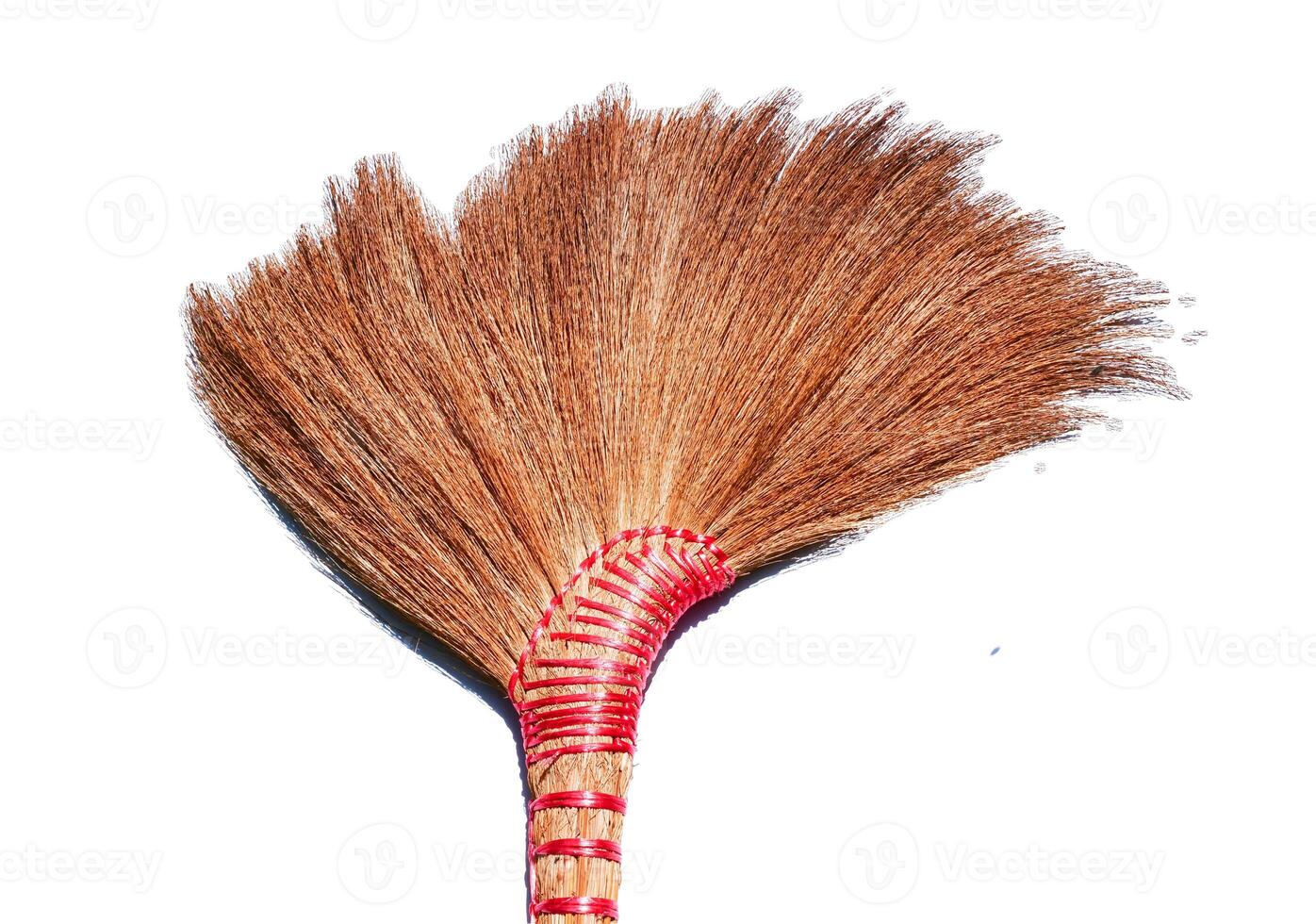 Traditional Handcrafted Broom with Natural Bristles Isolated on White Background for Cleaning and Home Decor photo