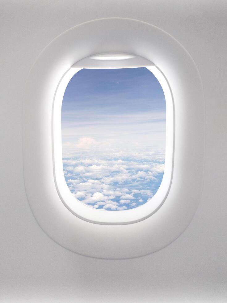 View of a clear sky with fluffy clouds in an open airplane cabin. photo