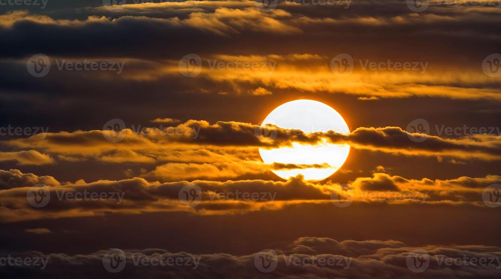 A bright sun behind clouds at sunset. photo
