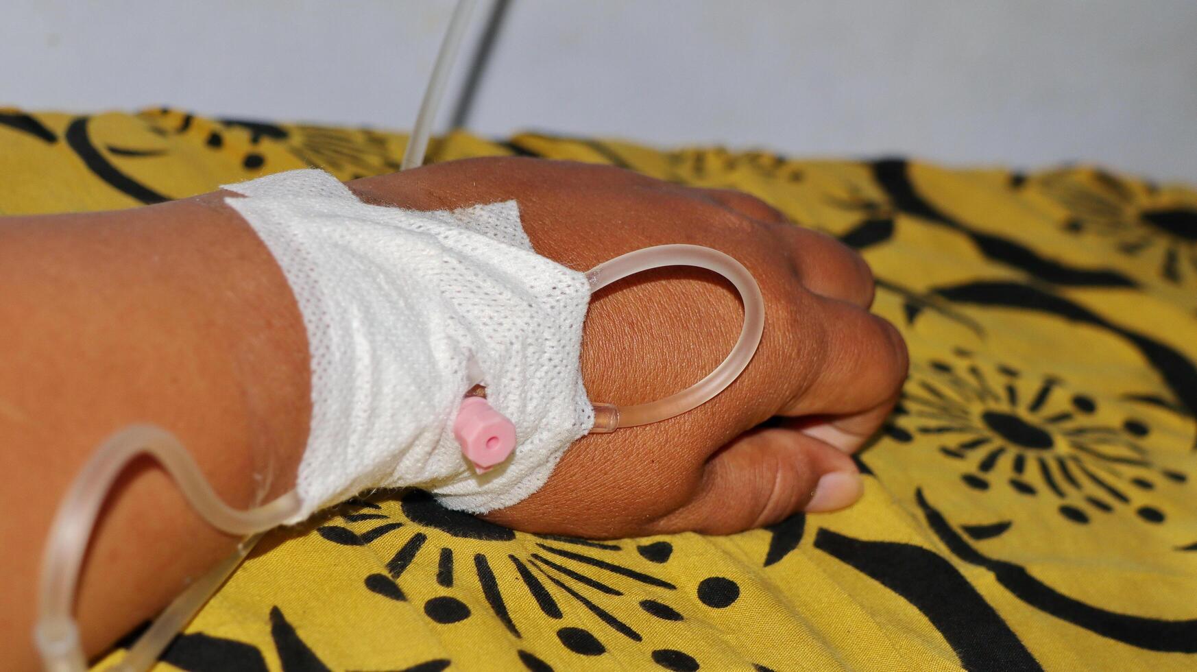 person's hand being given an IV photo