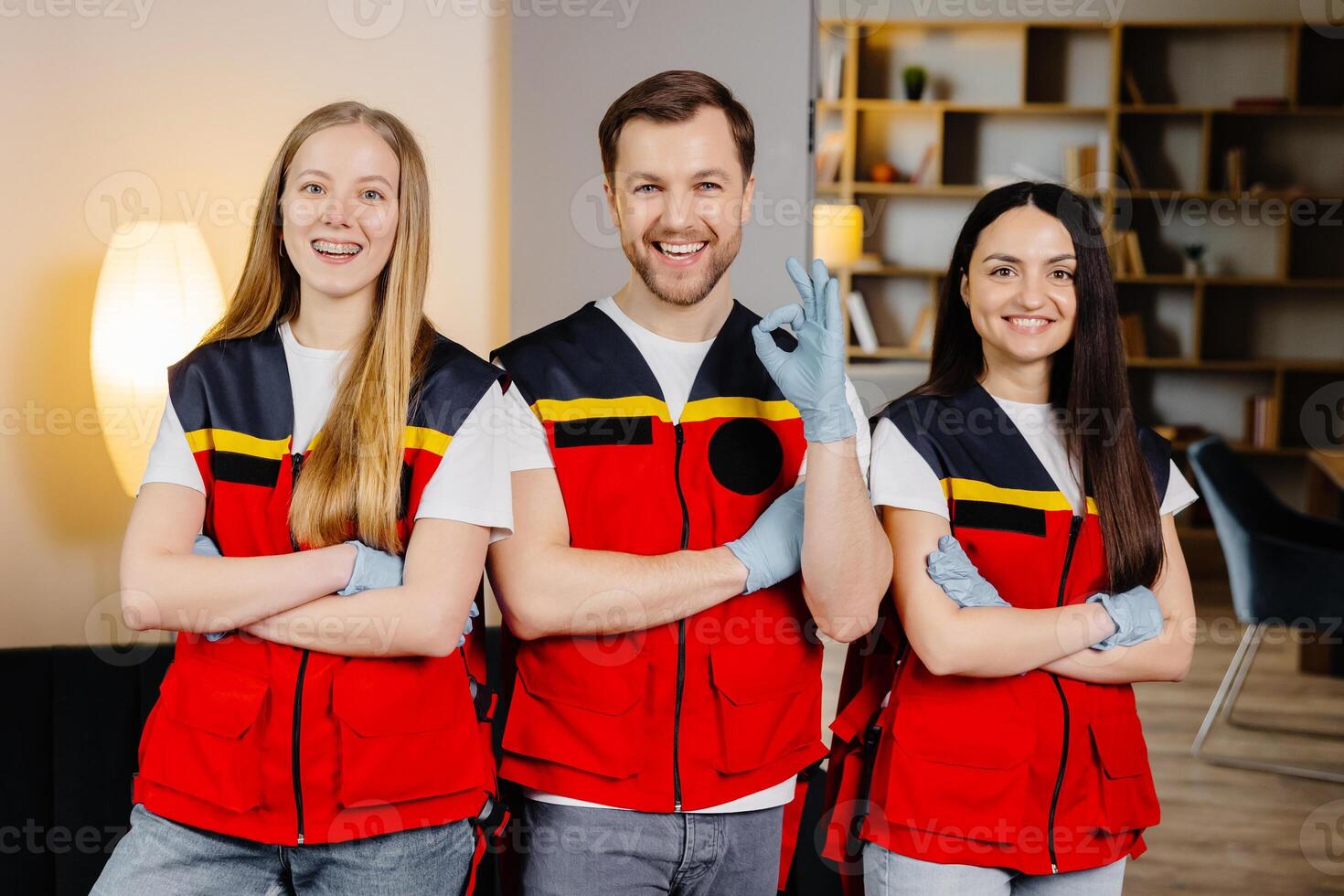 Group of people with cpr dummy looking at camera and smiling after first aid training class photo