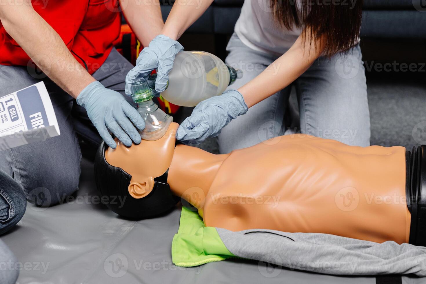 Woman holding breathing bag Ambu bag.Demonstrating CPR Cardiopulmonary resuscitation training medical procedure on CPR doll in the class.Paramedic demonstrate first aid practice for save life photo