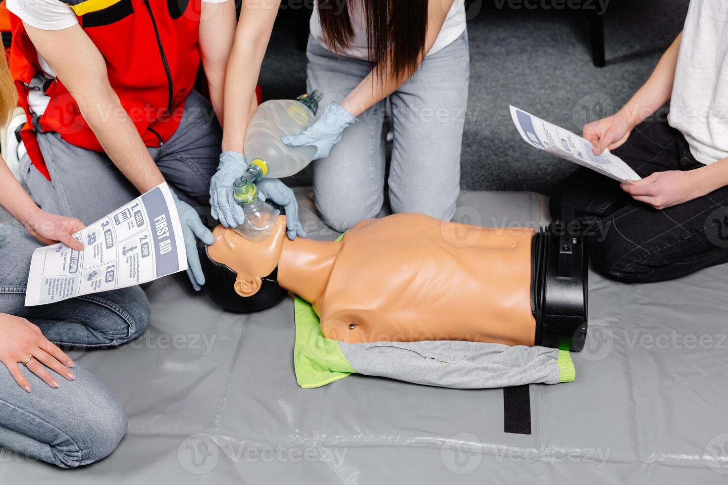 Woman holding breathing bag Ambu bag.Demonstrating CPR Cardiopulmonary resuscitation training medical procedure on CPR doll in the class.Paramedic demonstrate first aid practice for save life photo