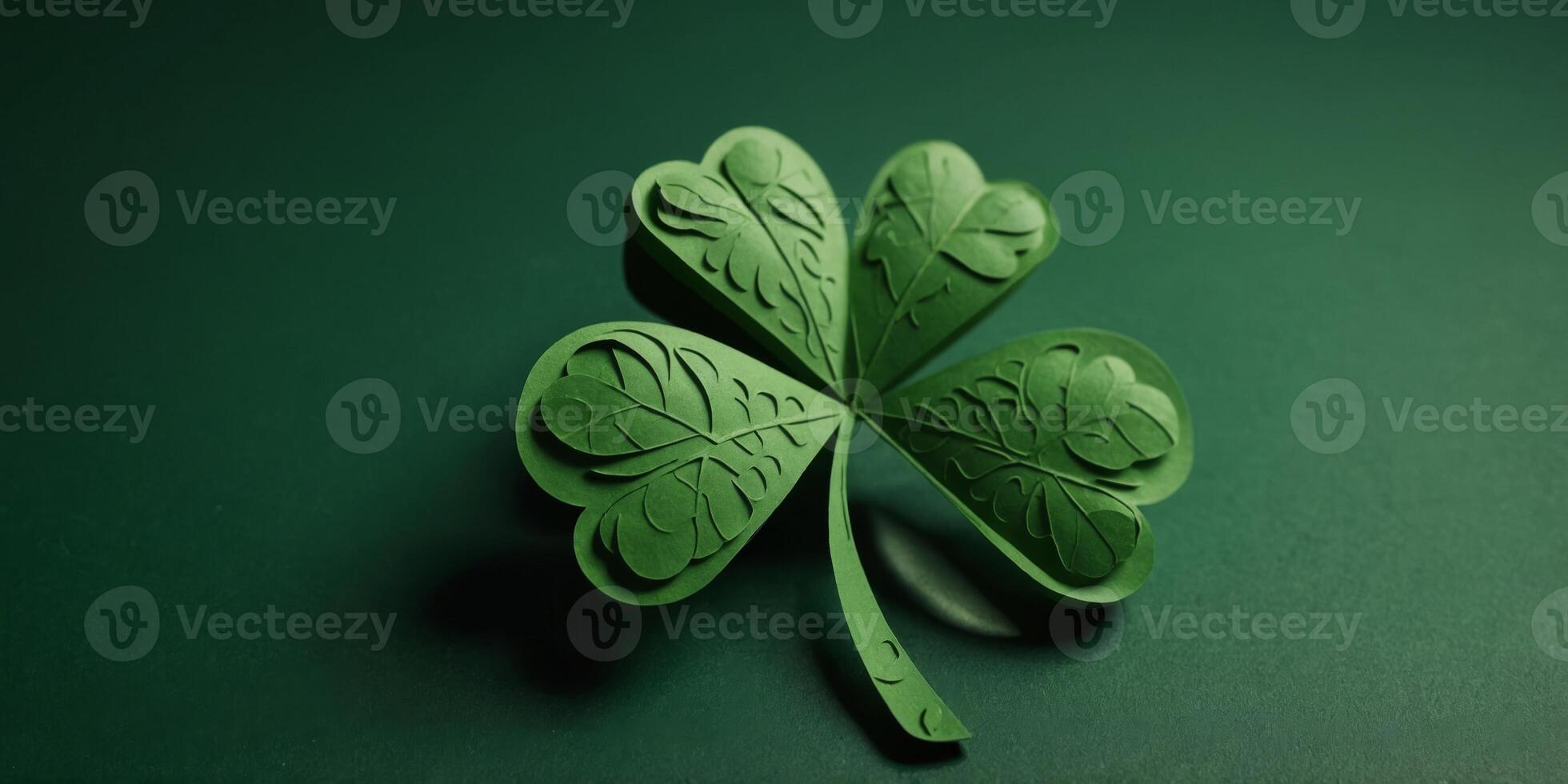 St Patricks day four leaf clover paper cut on green background. photo