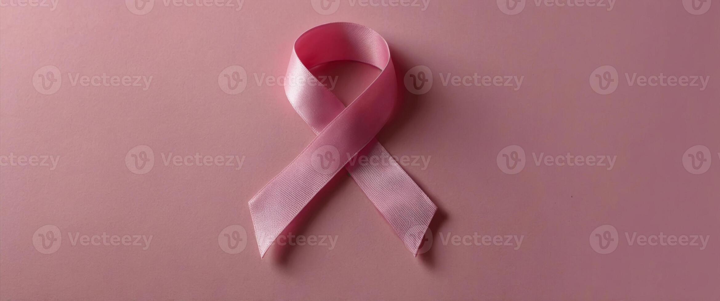 World Breast Cancer Day Pink ribbon on pink background, copy space. photo