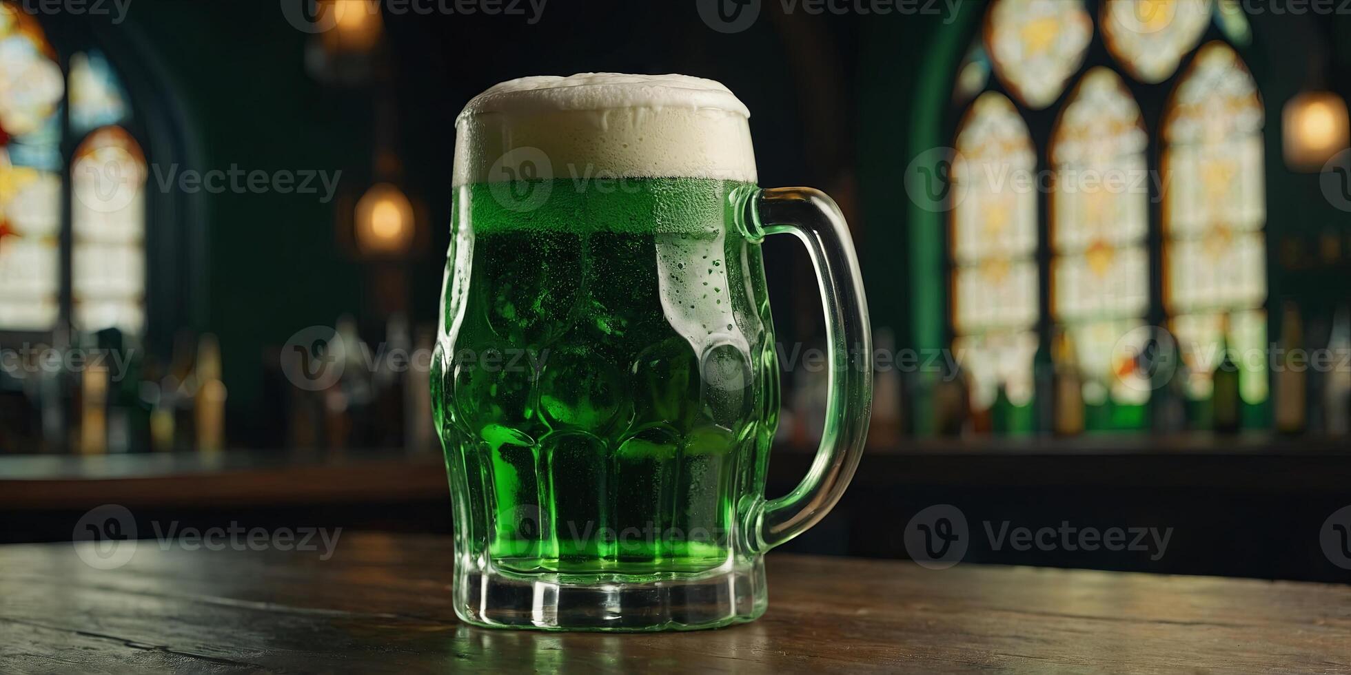 glass and bottle of green beer with foam on table, st patricks day concept. photo