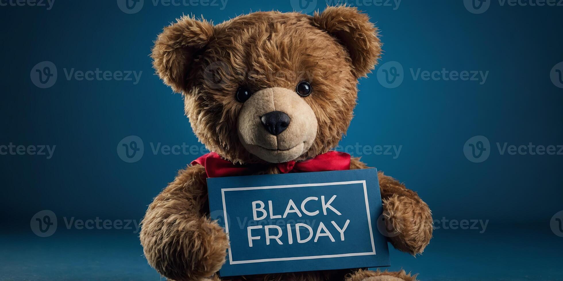 teddy bear with sign black friday on blue background with copy space. photo