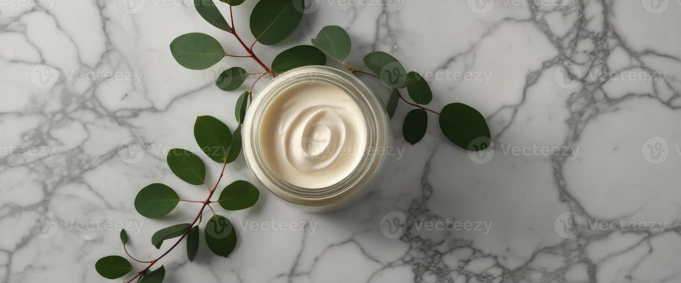 Natural organic cream jar with eucalyptus leaves on marble background Flat lay, top view, copy space Natural organic product, beauty and spa concept. photo