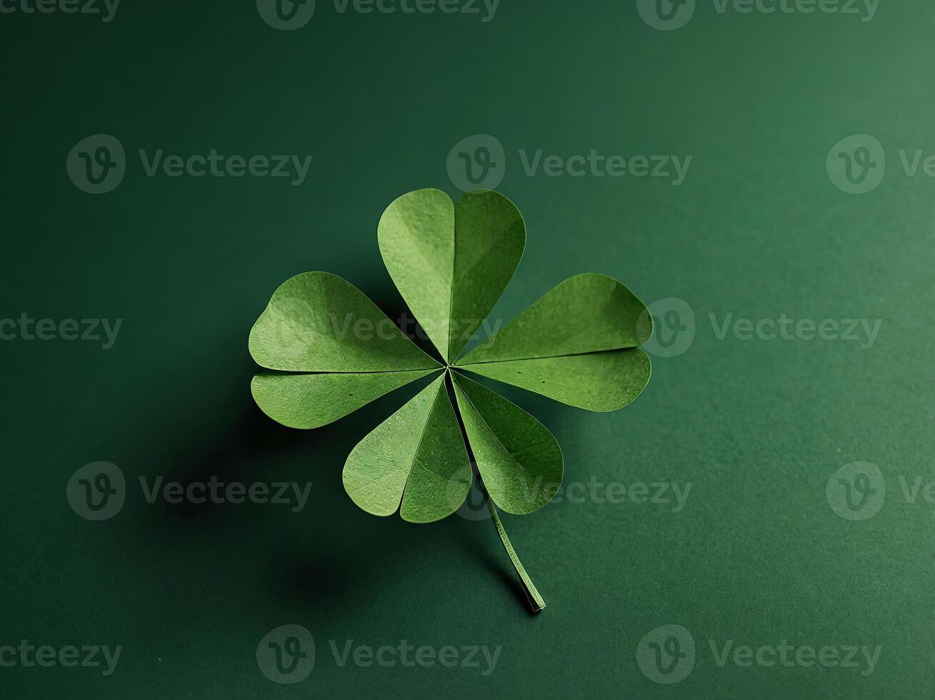 Paper art four-leaf clover made of small four-leaf clovers on green background. photo