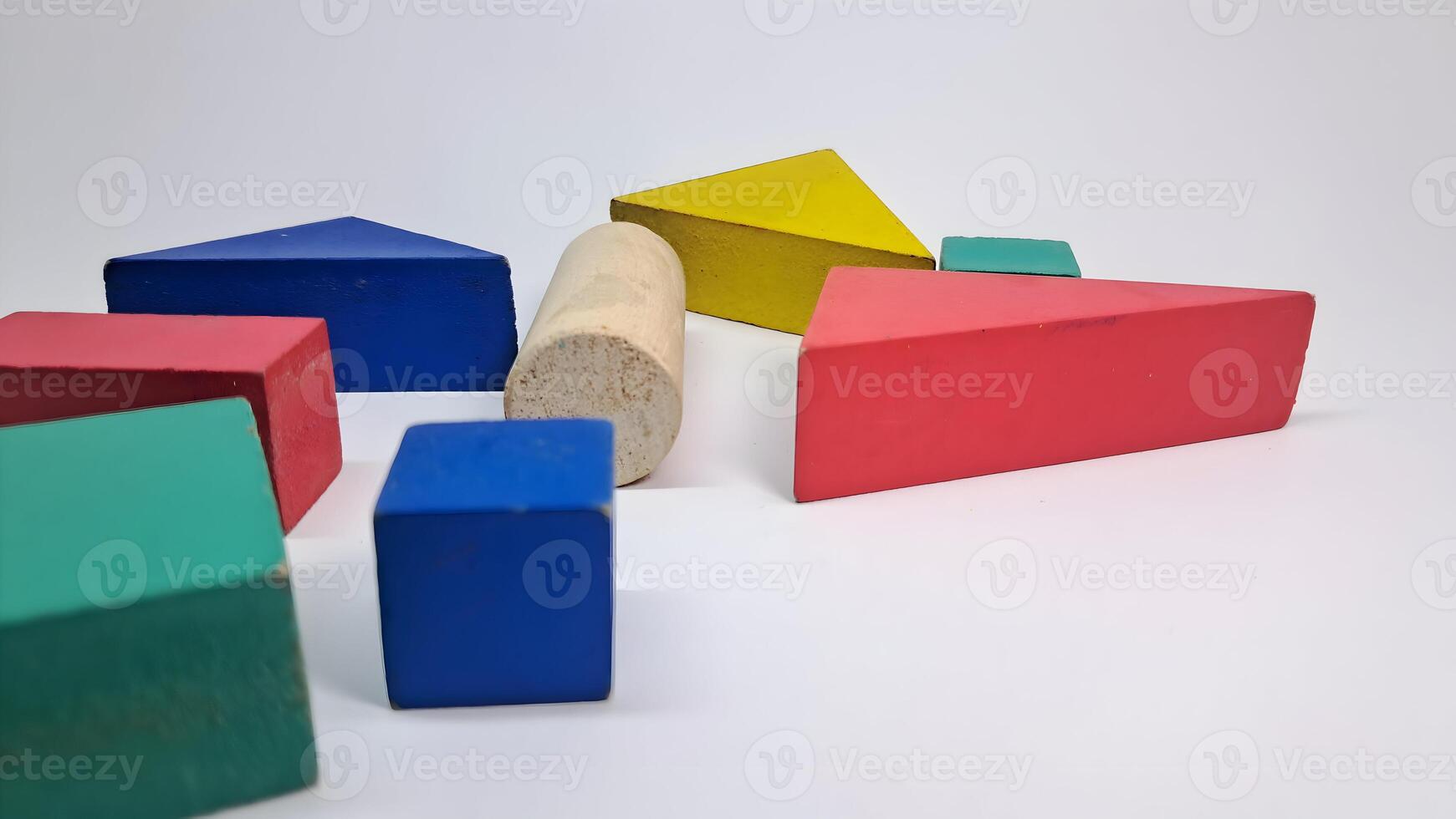 a group of colorful wooden blocks on a white surface photo