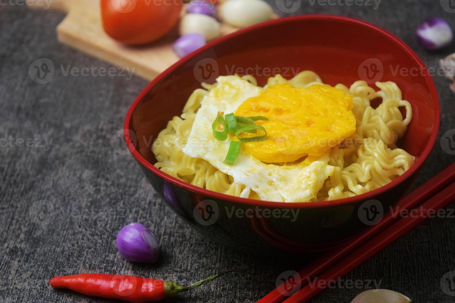 Closeup photo of a bowl of boiled noodles with fried egg