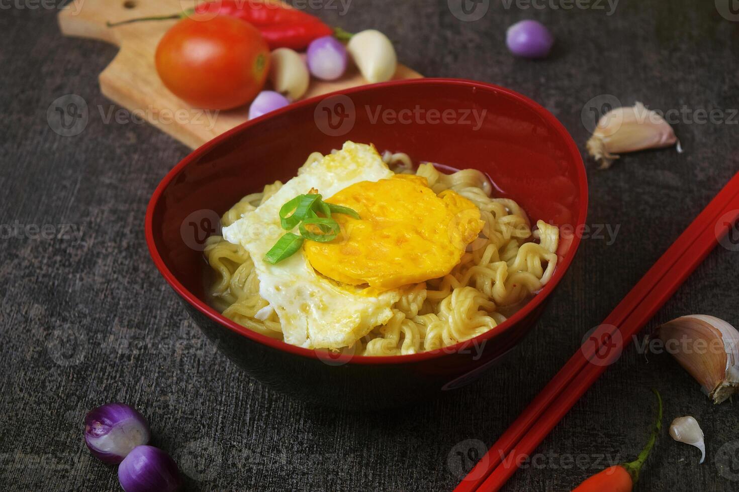 Closeup photo of a bowl of boiled noodles with fried egg