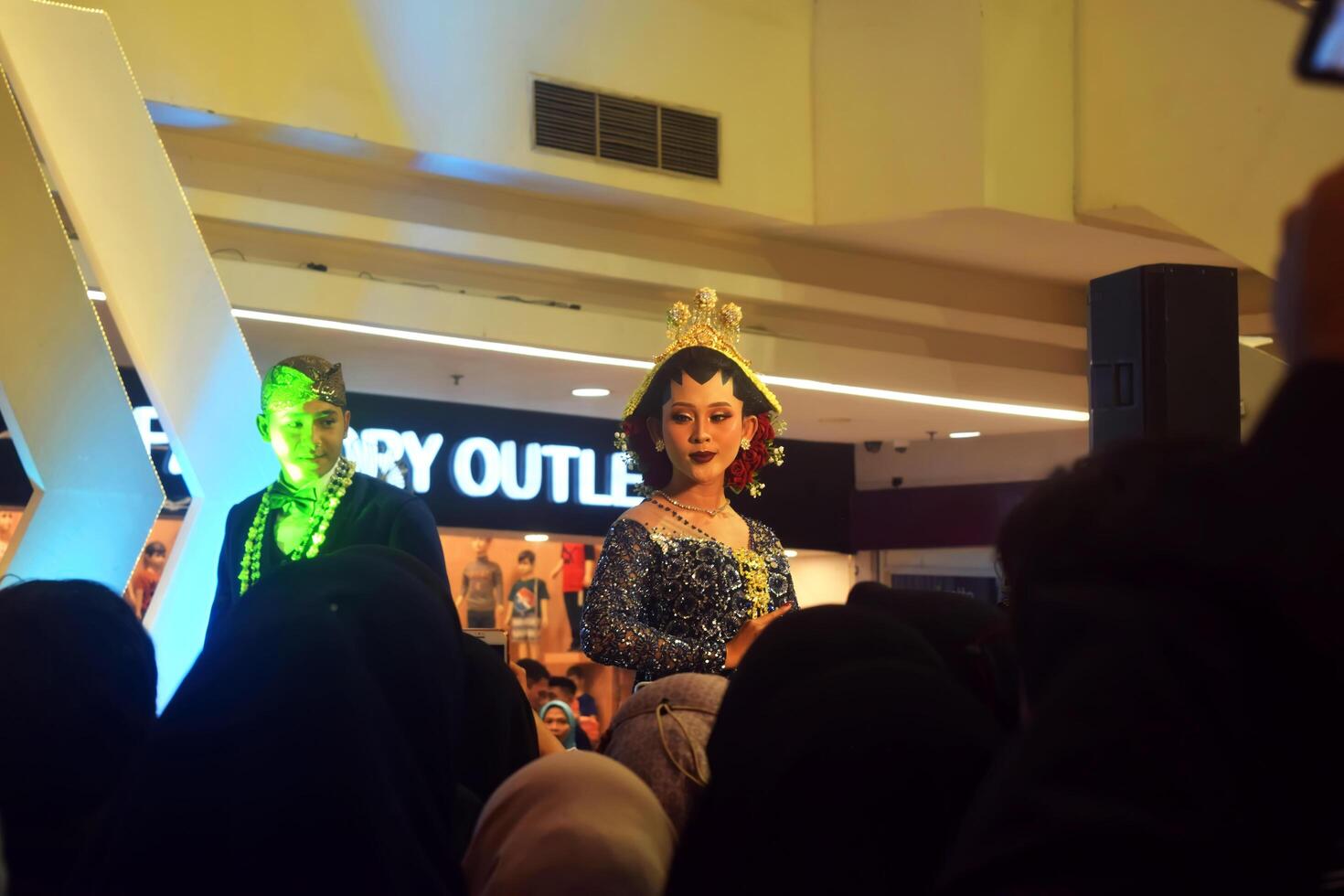 Tegal, Indonesia, 2023 - A model wearing a blue traditional dress at a wedding expo at a mall photo