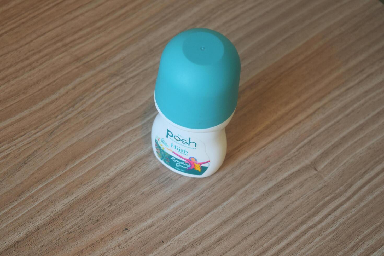 Semarang, Indonesia, 2023 - Green Posh brand deodorant is on a wooden table photo