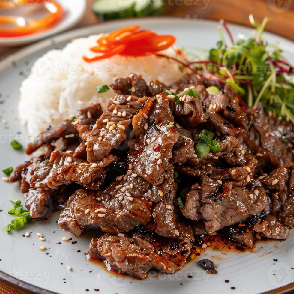 Grilled beef with sesame and onions on white plate closeup image. Traditional barbecue dish with rice and vegetables photo