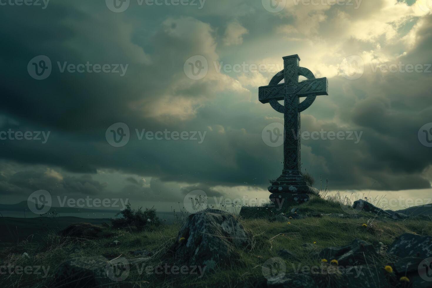 Celtic cross on the hill with dark clouds in the grey sky. Ancient gothic scary atmosphere photo