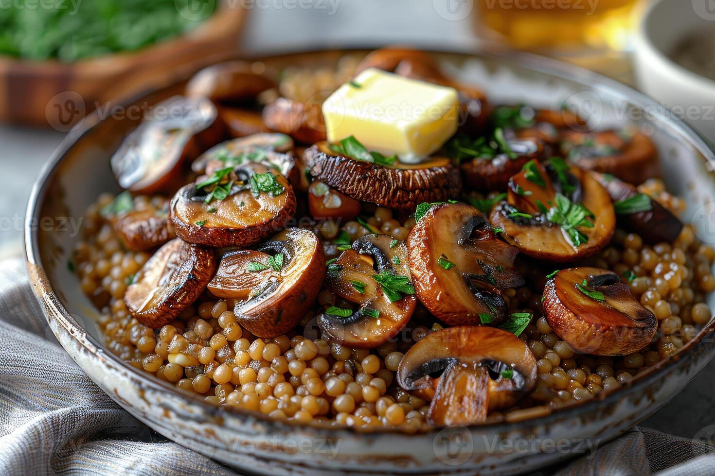 A bowl of buckwheat kasha with roasted mushrooms, garnished with fresh parsley and a pat of butter. photo