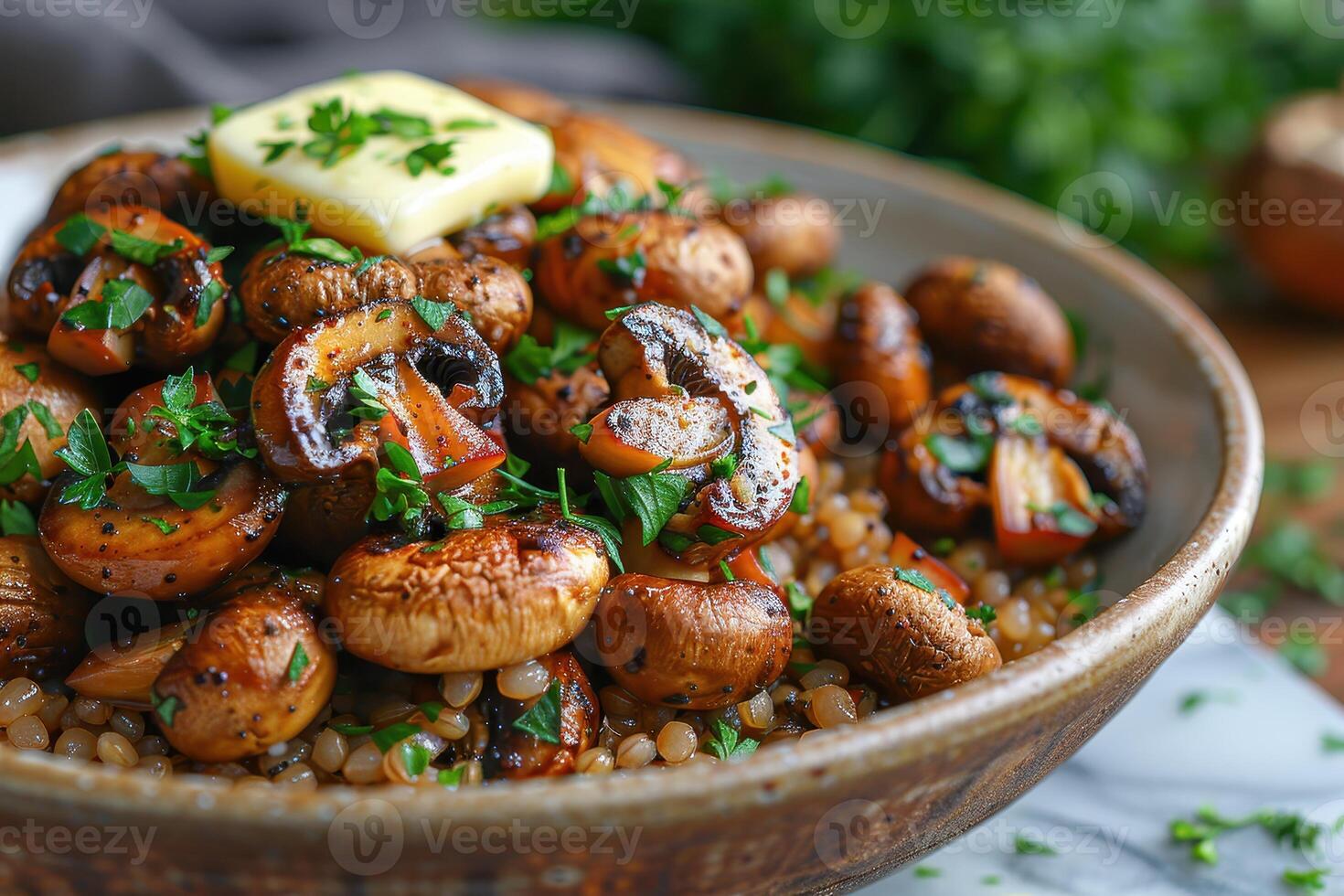 A bowl of buckwheat kasha with roasted mushrooms, garnished with fresh parsley and a pat of butter. photo