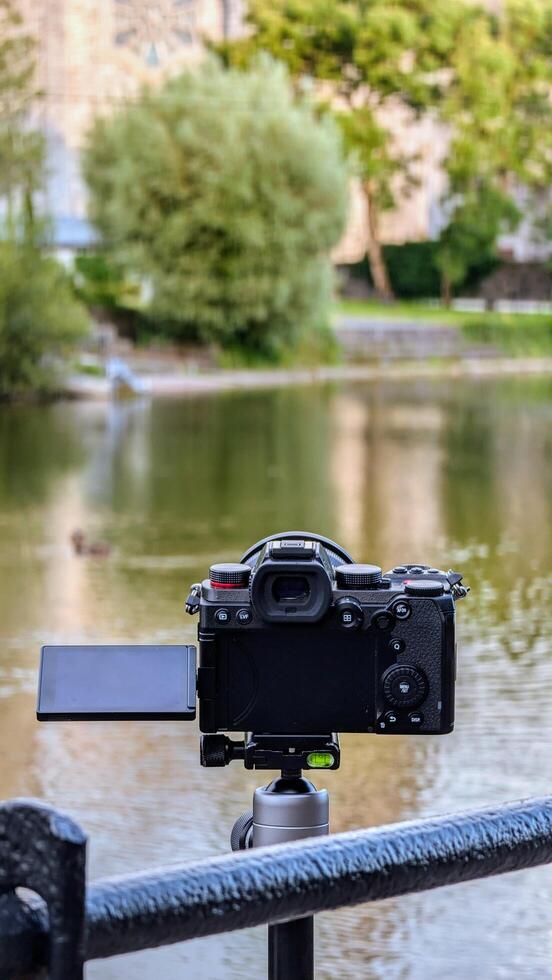 Closeup of modern mirrorless dslr camera recording beautiful scene at Galway, ireland, technology concept background photo