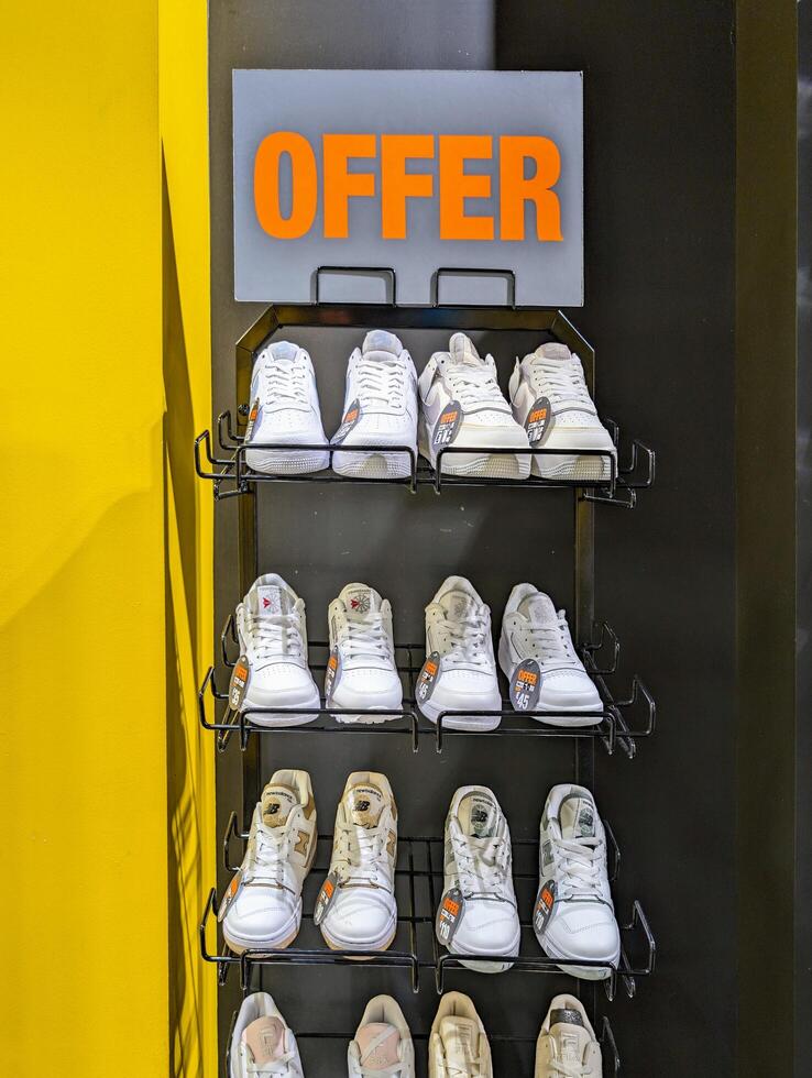 Galway, Ireland - Jun 02. 2024, Sneakers and trainers brands on shelf in shoe shop, fashion and lifestyle, popular clothing and apparel photo