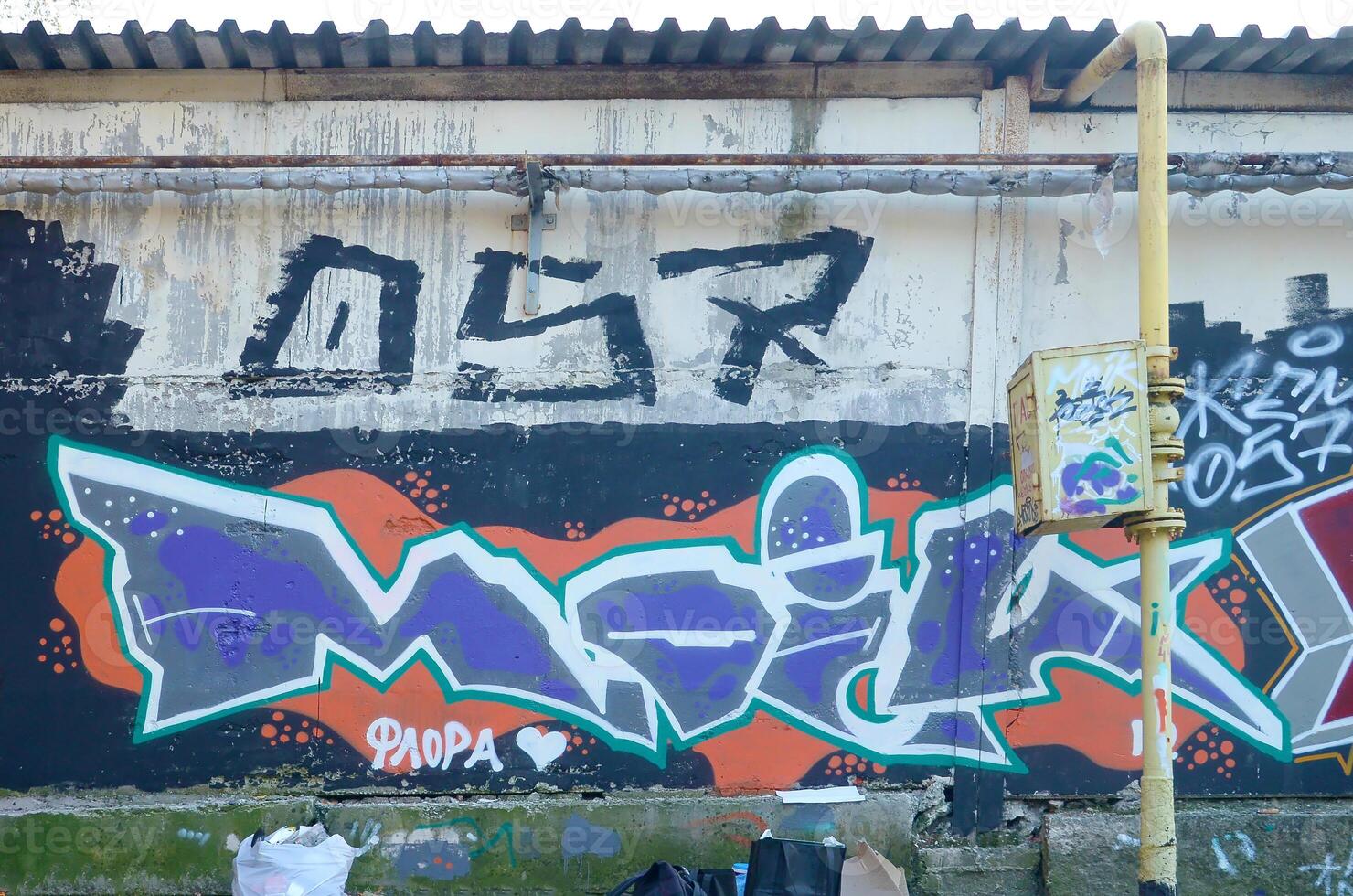 Colorful background of graffiti painting artwork with bright aerosol outlines on wall. Old school street art piece made with aerosol spray paint cans. Contemporary youth culture photo