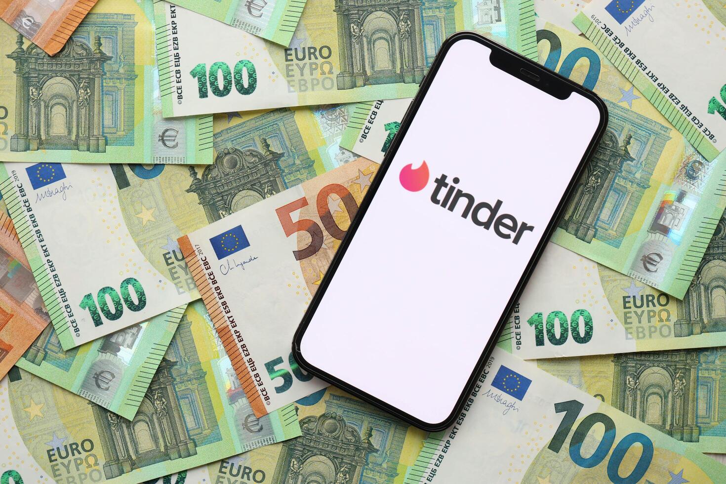 KYIV, UKRAINE - FEBRUARY 23, 2024 Tinder logo of famous dating website or app on iPhone display photo