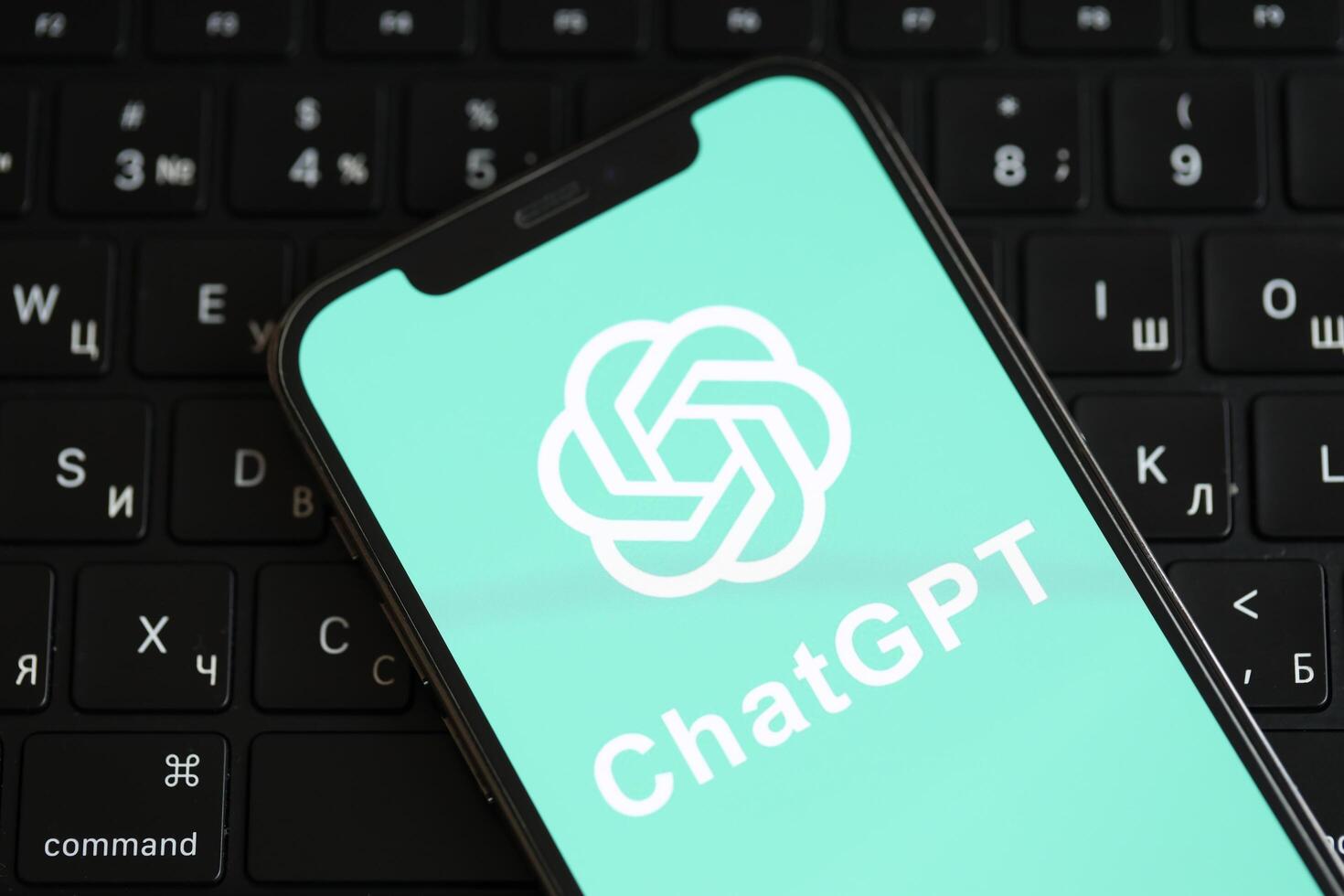 KYIV, UKRAINE - MARCH 17, 2024 ChatGPT logo on iPhone display screen and MacBook keyboard photo