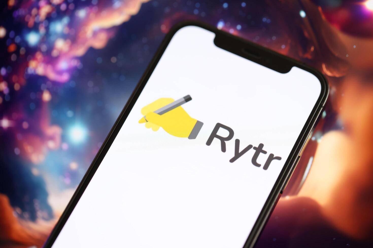 KYIV, UKRAINE - MARCH 17, 2024 Rytr logo on iPhone display screen with background of artificial intelligence futuristic image photo
