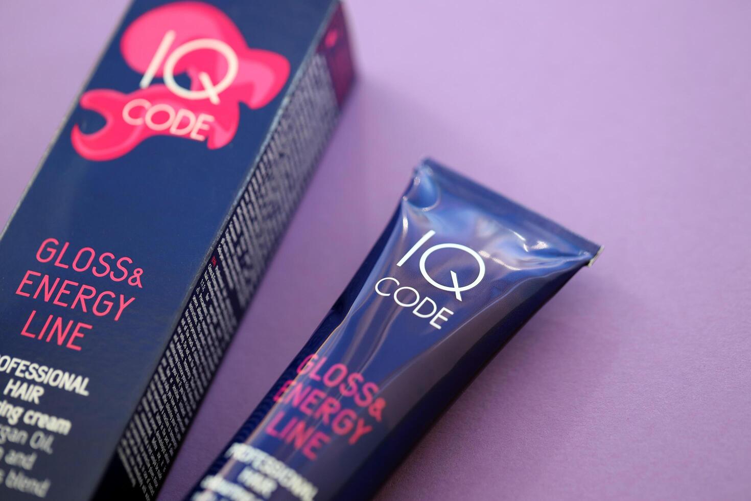 KYIV, UKRAINE - OCTOBER 31, 2023 Tube of IQ Code Gloss and Energy Line colorizer cream for hair photo