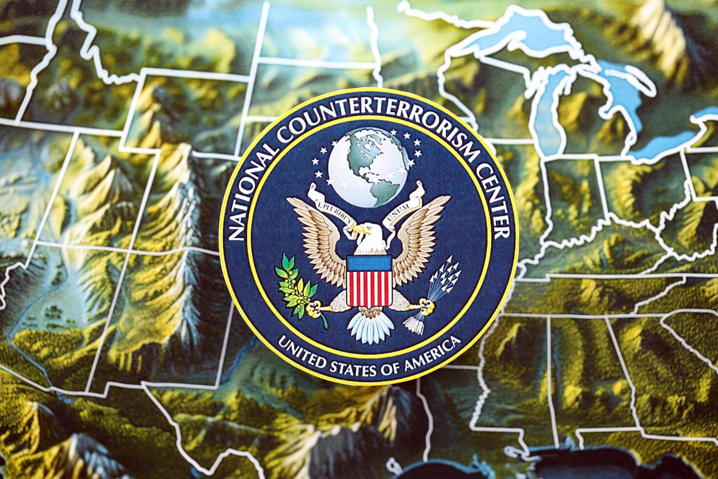 KYIV, UKRAINE - JUNE 26, 2024 United States National Counterterrorism Center coat of arms on paper map of United States photo