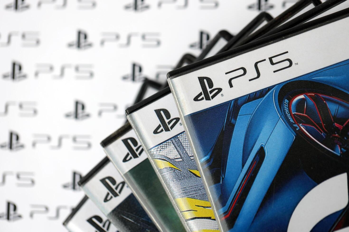 KYIV, UKRAINE - JUNE 26, 2024 Stack of games for Sony Playstation 5 and 4 console. Many disc boxes of popular games photo