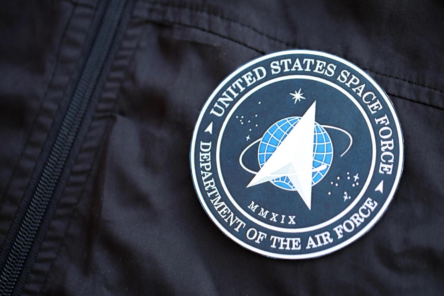 KYIV, UKRAINE - JUNE 26, 2024 United States Space Force Department of the Air Force coat of arms as pin on black uniform jacket photo