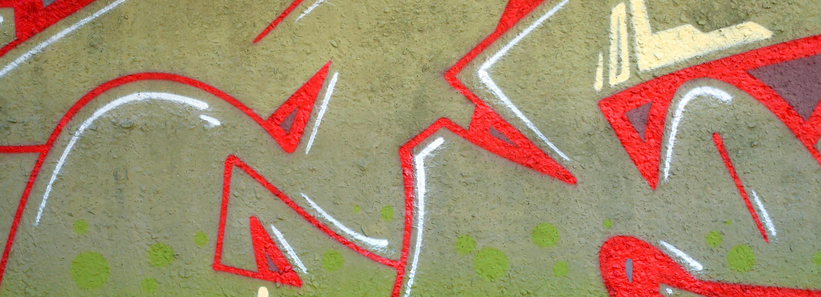 Colorful background of graffiti painting artwork with bright aerosol outlines on wall. Old school street art piece made with aerosol spray paint cans. Contemporary youth culture photo