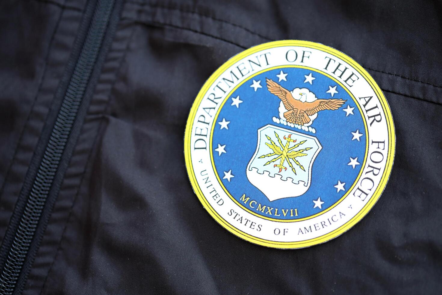 KYIV, UKRAINE - JUNE 26, 2024 United States Department of the Air Force coat of arms as pin on black uniform jacket photo