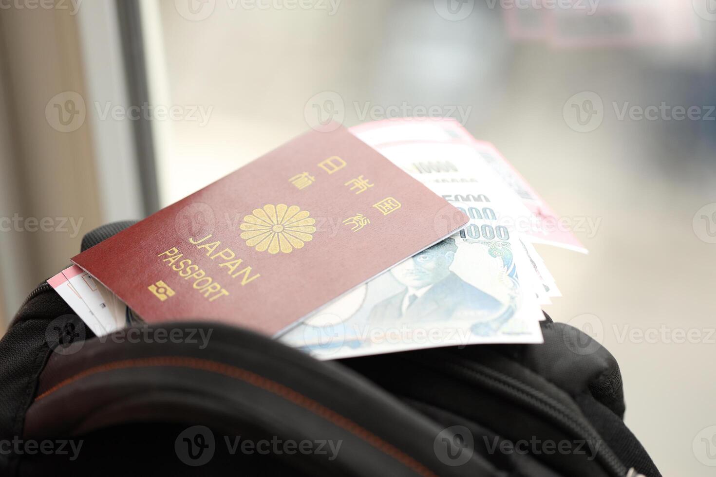 Japan passport with japanese yen money bills with airline tickets on backpack photo