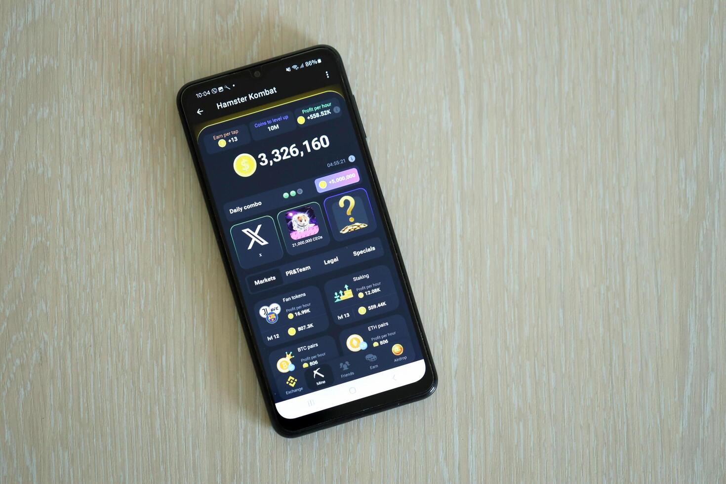 KYIV, UKRAINE - APRIL 20, 2024 Hamster Kombat telegram bot on smartphone screen. Hamster Kombat is a viral Telegram crypto game for earn HMSTR tokens by managing virtual crypto exchange photo