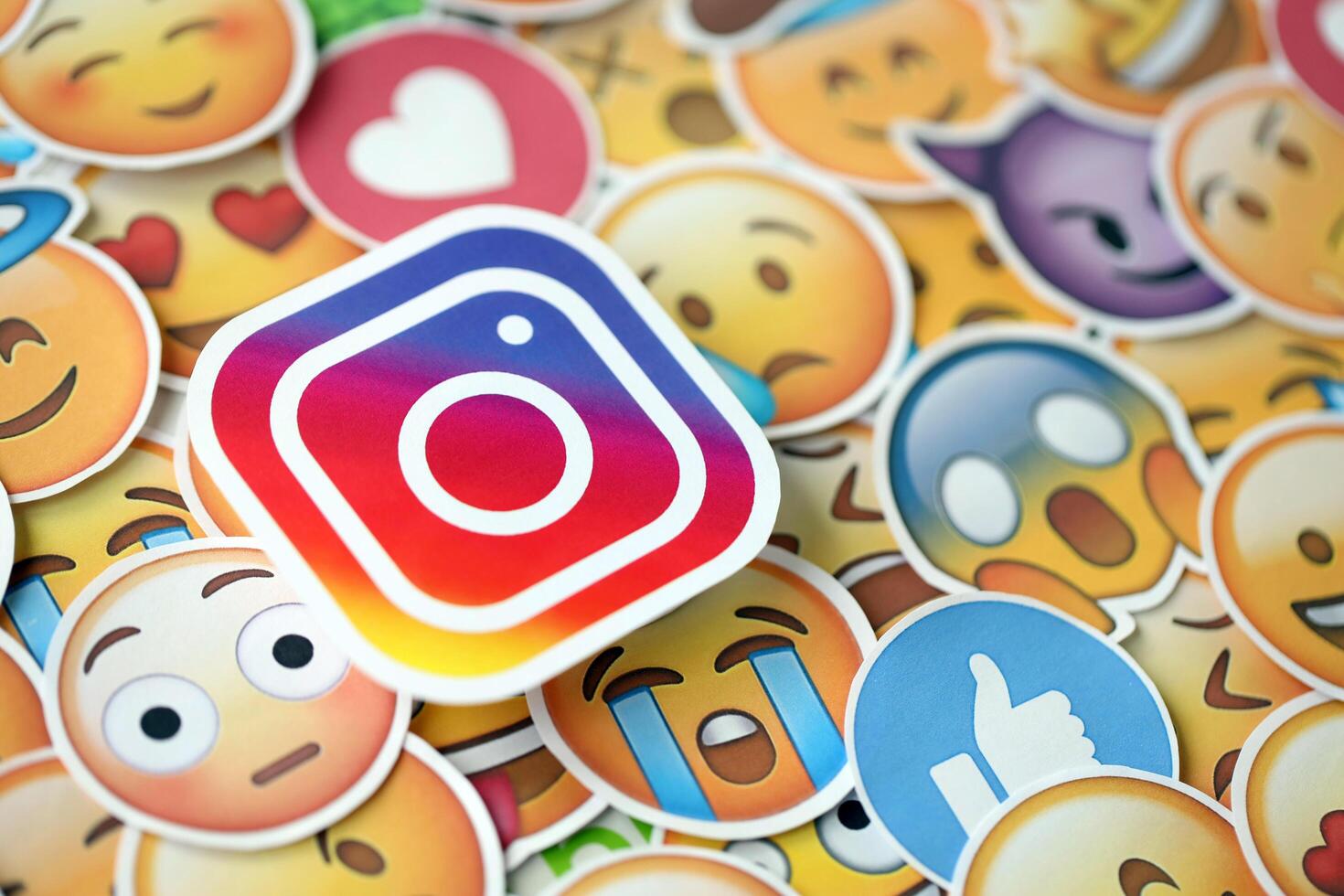 KYIV, UKRAINE - APRIL 20, 2024 Instagram logo and large set of stickers with Emoji yellow faces. Emoji is a pictogram or smiley embedded in text and used in electronic messages photo