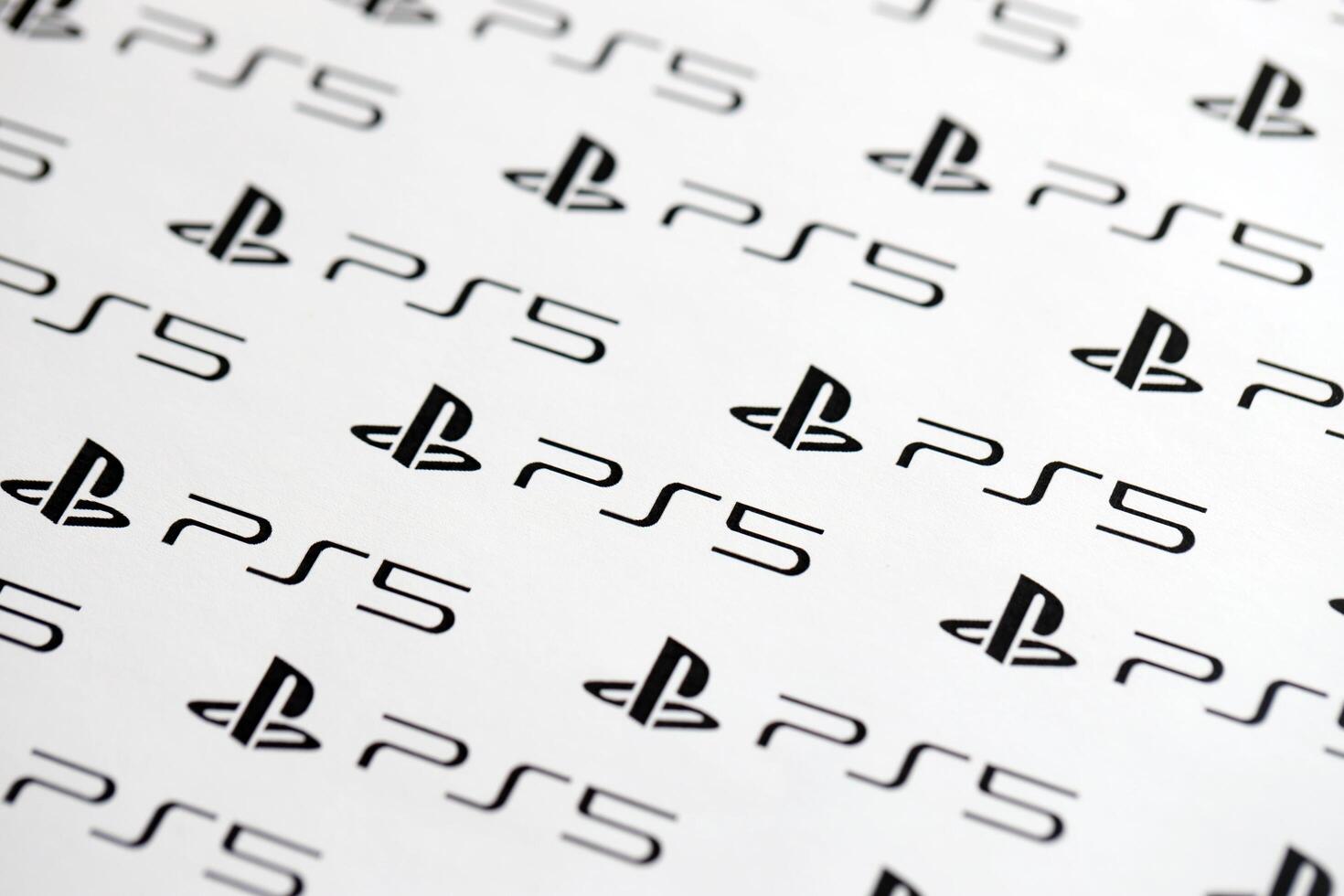 KYIV, UKRAINE - JUNE 26, 2024 Sony Playstation 5 console logo repeating many times on white paper background banner photo