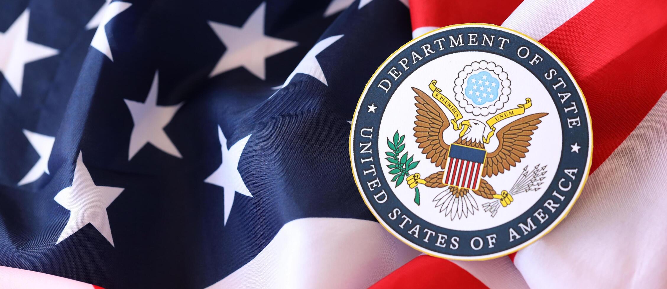 KYIV, UKRAINE - MARCH 9, 2024 US Department of State seal on United States of America flag photo
