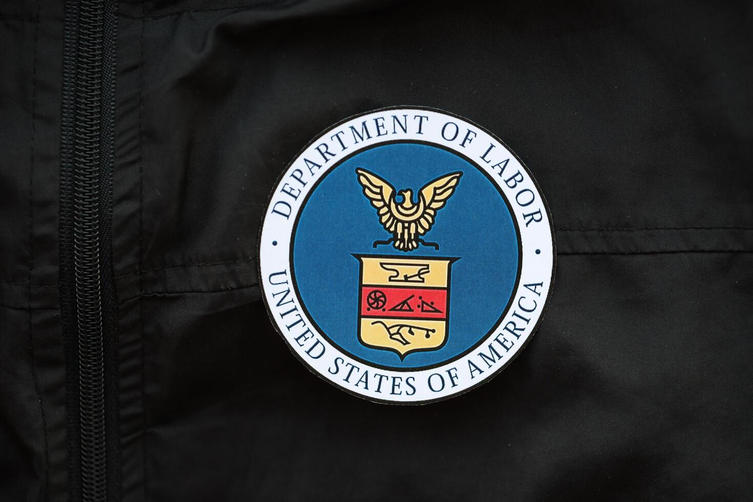 KYIV, UKRAINE - MARCH 9, 2024 US Department of Labor seal on black jacket uniform photo