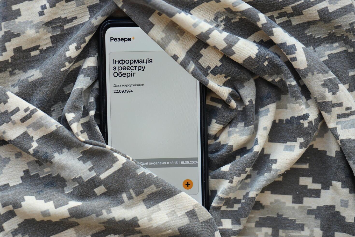 KYIV, UKRAINE - JUNE 20, 2024 Rezerv plus - ukrainian application for smartphone with actual personal information about conscript status for military recruits photo